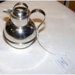 A 10cm high silver jug with lid