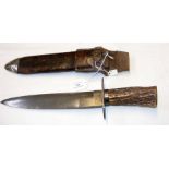 An old horn handled Bowie knife with leather scabb