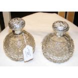 A pair of silver lidded cut glass scent bottles