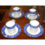 A set of four coffee cans and saucers with pierced