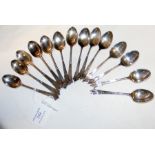 A set of silver teaspoons and one other