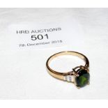 An emerald and diamond ring in gold setting