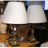 A pair of decorative cast metal table lamps