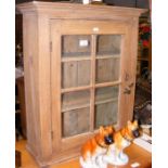 A small antique pine hanging cupboard