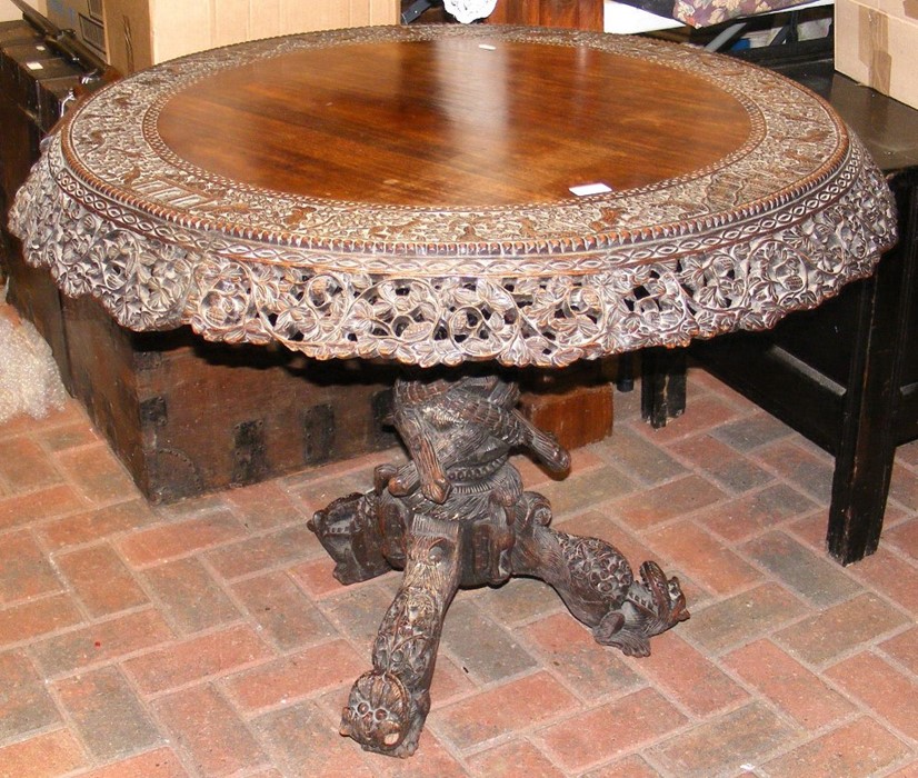 A heavily carved Anglo Indian tilt-top table with