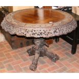 A heavily carved Anglo Indian tilt-top table with