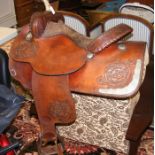 Decorative leather horse saddle with metal embelli