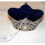 An elegant silver pierced sugar basket with blue g
