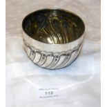 A silver bowl with swirl design