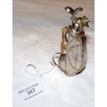 A silver miniature golf bag with thirteen numbered