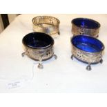 A set of four silver salts with blue glass liners