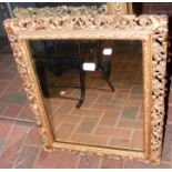 A decorative pierced gilt framed wall mirror