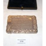A silver card case with engraved decoration in pre