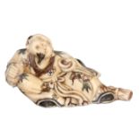 A FINELY CARVED AND ENGRAVED JAPANESE IVORY NETSUKE OF AN ELDER MAN signed to the base 7cm wide