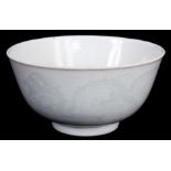 A CHINESE WHITE PORCELAIN RICE BOWL with pale green pipe work decoration of chasing dragons