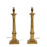 A PAIR OF BRASS CORINTHIAN LAMPS 47cm high.