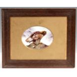 A HAND PAINTED OVAL PORCELAIN PLAQUE OF A GOLDEN EAGLE - framed and mounted 9cm high 12cm wide.