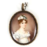 A 19th CENTURY PORTRAIT MINIATURE ON IVORY of a young lady with flowers in her hair in cased gold