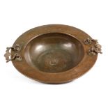 AN 18TH CENTURY EASTERN PATINATED BRASS FOOTED BOWL with spun bowl and flattened rim fitted with