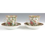A PAIR OF 19TH CENTURY CANTON TEA CUPS AND SAUCERS brightly painted with village scenes and floral
