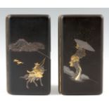 A PAIR OF JAPANESE DAMASCENE CIGARETTE CASES decorated in silver and gold inlay one depicting a