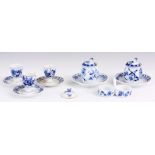 A PAIR OF MEISSEN BLUE AND WHITE CONDIMENT POTS AND COVERS ON STANDS, A SMALL DOUBLE SIDED DISH,