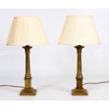 A PAIR OF BRASS CORINTHIAN LAMPS 47cm high.