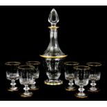 A CONTINENTAL GILT AND BLACK PAINTED DECANTER AND SIX MATCHING GOBLETS of facetted from 34cm and