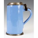 A SOUTH GERMAN TANKARD with hinged pewter lid and pale blue slip 21cm high.