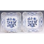 A PAIR OF MEISSEN BLUE AND WHITE SQUARE LATTICE WORK DISHES decorated in the blue onion pattern 24cm