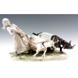 A MEISSEN PORCELAIN ANIMAL FIGURE GROUP modelled and decorated as a Dutch girl leading a pair of