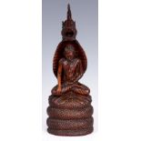 A 19th CENTURY CARVED BURMESE ROSEWOOD STATUE OF THE NAGA COBRA PROTECTING THE BUDDHA with a