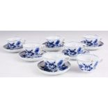 A SET OF SIX MEISSEN BLUE AND WHITE COFFEE CUPS AND SAUCERS decorated in the blue onion pattern.