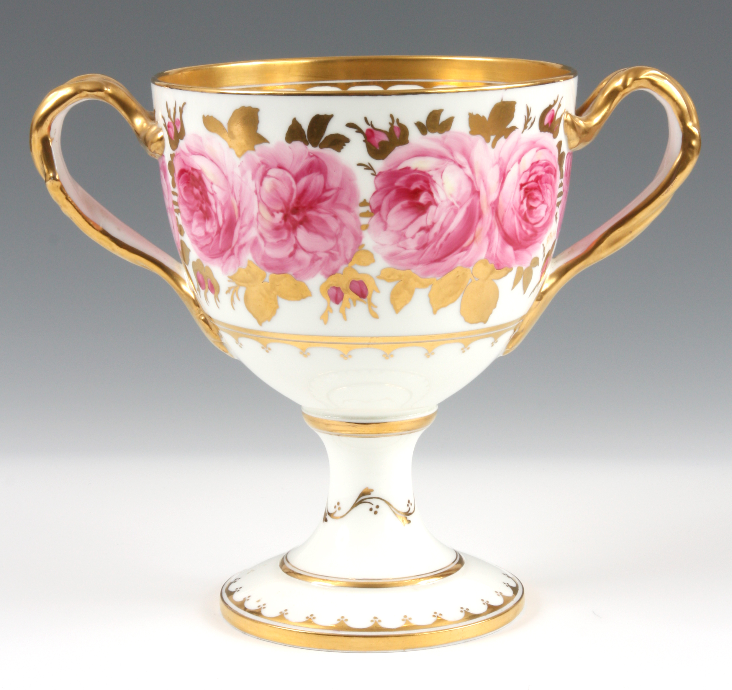 A LATE 19TH CENTURY CAULDON ROSE PATTERN PORCELAIN LOVING CUP decorated with gilt work and pink