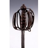 A 17th CENTURY SCOTTISH BASKET HILTED BACKSWORD with unusual double fuller curved blade leading to a