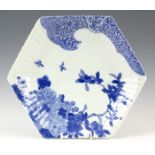 AN 18th CENTURY BLUE AND WHITE CHINESE HEXAGONAL CHARGER of ribbed form with insects and floral