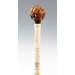 A CHINESE SECTIONAL BONE WALKING CANE WITH CARVED BOXWOOD HANDLE the stick scrimshawed depicting