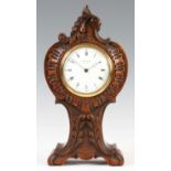 AN EARLY 20th CENTURY FRENCH OAK CASED MANTEL CLOCK with carved balloon shaped case enclosing a 3.5”