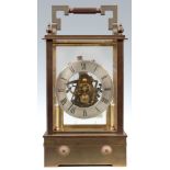 A MID 20th CENTURY ELECTRIC EUREKA STYLE BRASS CASED MANTEL CLOCK the heavy brass case with glazed