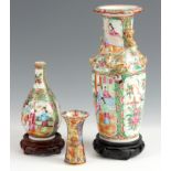 THREE 19TH CENTURY ORIENTAL VASES including a small bulbous canton vase, a larger canton vase with