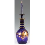 A LARGE REGENCY BRISTOL BLUE DECANTER of ringed tapering form with a spire finial, decorated with