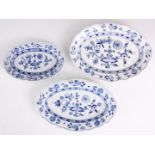 A GRADUATED SET OF THREE MEISSEN BLUE AND WHITE OVAL SCALLOPED EDGE DISHES decorated in the blue