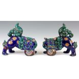 A PAIR OF 19TH CENTURY CHINESE PORCELAIN FOO DOGS with polychrome decoration 23cm high 15cm wide.