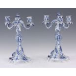 A PAIR OF MEISSEN BLUE AND WHITE PORCELAIN THREE BRANCH TABLE CANDELABRA with scroll moulded stems