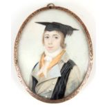 A 19th CENTURY PORTRAIT MINIATURE ON IVORY of a young scholar in gold metal engraved frame with
