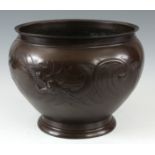 A MEIJI PERIOD JAPANESE PATINATED BRONZE JARDINIERE having embossed dragon decoration with gilt