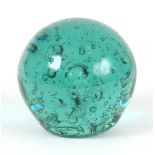 A 19TH CENTURY GREEN GLASS DUMP/PAPERWEIGHT with speckled air bubble decoration 13cm high.