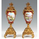 A PAIR OF LATE 19TH CENTURY CONTINENTAL GILT METAL MOUNTED PORCELAIN URN SHAPED VASES 25.5cm high.