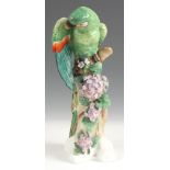 AN EARLY 20TH CENTURY CONTINENTAL PORCELAIN FIGURE OF A PORTLAND PARROT 27cm high.