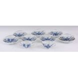 A SET OF NINE MEISSEN BLUE AND WHITE TWO HANDLED DESSERT CUPS and seven scalloped saucers